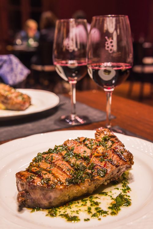 Argentina Travel Landscape Photography Argentinian Steak with red wine for dinner at a fine dining restaurant at a Bodega winery in the Maipu area of Mendoza Mendoza Province Argentina South America