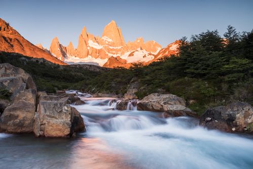 Argentina Travel Landscape Photography Sunrise Mount Fitz Roy aka Cerro Chalten and waterfall seen on Lago de los Tres hike El Chalten Patagonia Argentina South America