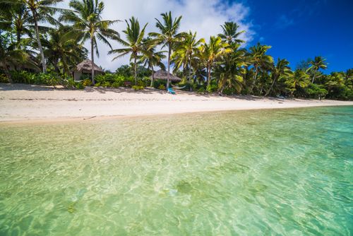Cook Islands Landscape Travel Photography Crystal clear Pacific Ocean water and tropical white sandy beach with palm trees at Titikaveka Rarotonga Cook Islands background with copy space 2