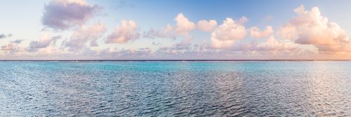 Cook Islands Landscape Travel Photography Dramatic clouds at sunset with a cloudscape over a horizon of the blue waters of the Pacific Ocean on the tropical island of Rarotonga Cook Islands