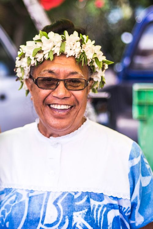 Cook Islands Landscape Travel Photography Maori woman wearing a lei string of flowers at Rarotonga Saturday Market Punanga Nui Market Avarua Town Cook Islands