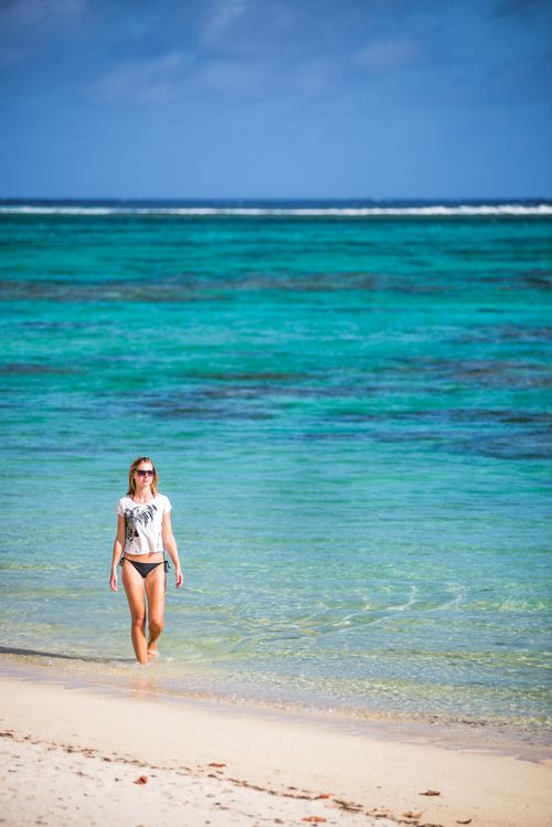 Cook Islands Landscape Travel Photography Woman walking along a tropical baech Rarotonga Island Cook Islands 3