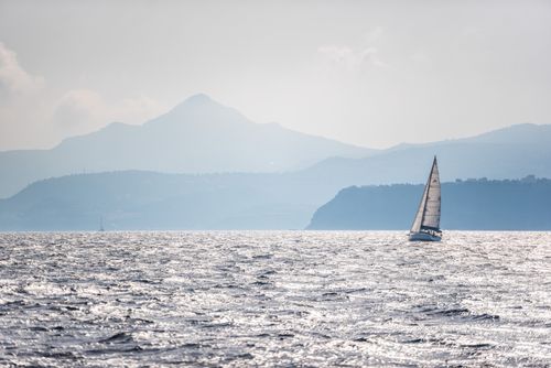 Greece Travel Photography Sailing boats in Athens harbour with dramatic mountains behind while on vacation Attica Region Greece Europe background with copy space