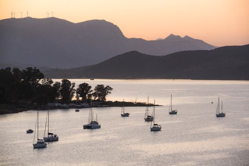 Greece Travel Photography Sailing boats in Poros Island port at sunset Saronic Island Aegean Coast Greece