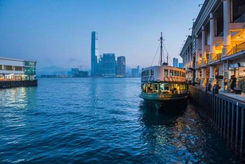 Hong Kong Travel Photography Star Ferry leaving Hong Kong Island towards Kowloon at night Hong Kong China