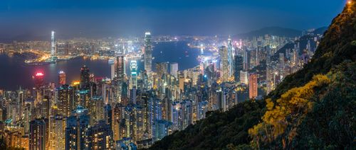 Hong Kong Travel Photography View over Hong Kong Island Victoria Harbour and Kowloon at night seen from Victoria Peak China