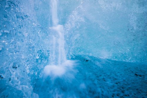 Iceland Landscape Photography Glacier Waterfall in an ice cave on Breidamerkurjokull Glacier Vatnajokull Ice Cap Iceland Europe background with copy space