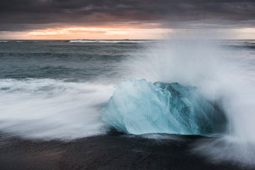 Iceland Landscape Photography Iceberg at sunrise on Jokulsarlon Beach a black volcanic sand beach in South East Iceland