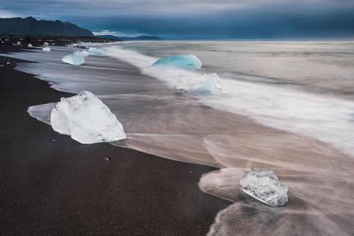 Iceland Landscape Photography Icebergs at sunrise on Jokulsarlon Beach a black volcanic sand beach in South East Iceland