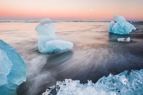Iceland Landscape Photography Icebergs at sunset on Jokulsarlon Beach a black volcaic sand beach in South East Iceland