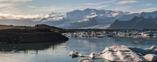 Iceland Landscape Photography Tourists at Jokulsarlon Glacier Lagoon at sunset South East Iceland Europe