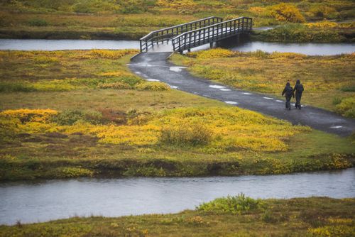 Iceland Travel Photography Couple walking in Rift Valley Thingvellir Pingvellir National Park The Golden Circle Iceland Europe