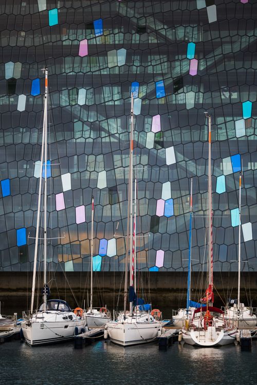 Iceland Travel Photography Harpa Concert Hall and Conference Centre and boats in Reykjavik Harbour Iceland Europe