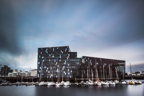 Iceland Travel Photography Harpa Concert Hall and Conference Centre and boats in Reykjavik Harbour Iceland