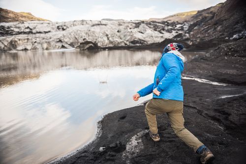 Iceland Travel Photography Skimming stones at Solheimajokull Glacier South Iceland Sudurland