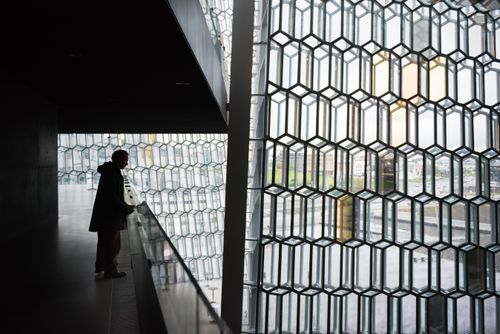 Iceland Travel Photography Tourist at Harpa Concert Hall and Conference Centre Reykjavik Iceland