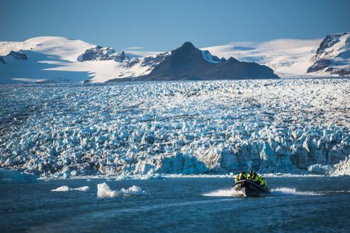 Iceland Travel Photography Zodiac boat tour on Jokulsarlon Glacier Lagoon with Breidamerkurjokull Glacier and Vatnajokull Ice Cap behind South East Iceland