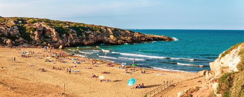 Italy Sicily Travel Photography Calamosche Beach panoramic photo of people sunbathing on the beach near Noto in the Vendicari Nature Reserve South East Sicily Italy Europe
