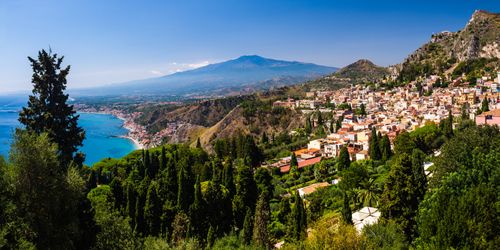 Italy Sicily Travel Photography Taormina panoramic photo of Mount Etna Volcano and Taormina seen from Teatro Greco aka Greek Theatre or Amphitheatre Sicily Italy Europe