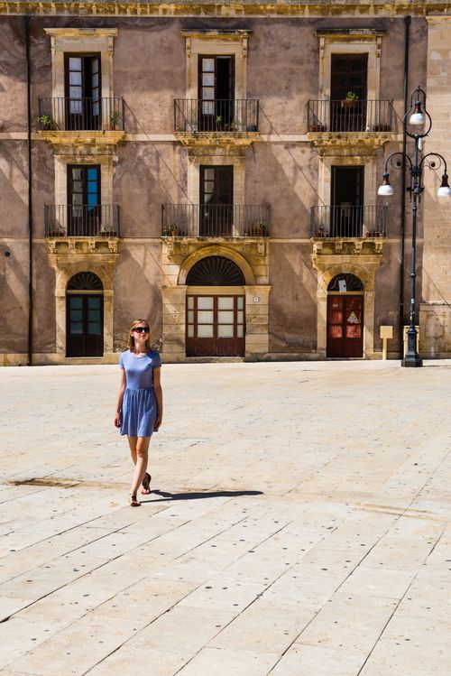 Italy Sicily Travel Photography Woman on holiday in Piazza Duomo in Ortigia Syracuse Siracusa UNESCO World Heritage Site Sicily Italy Europe
