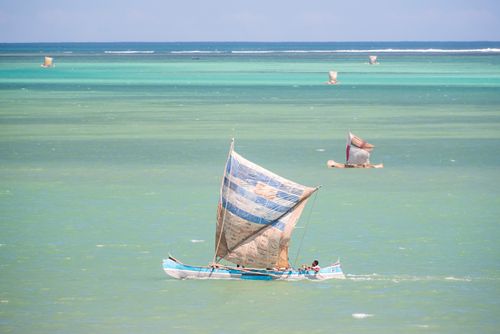Madagascar Travel Photography Fisherman fishing from a Pirogue a traditional Madagascar sailing boat Ifaty Madagascar Africa