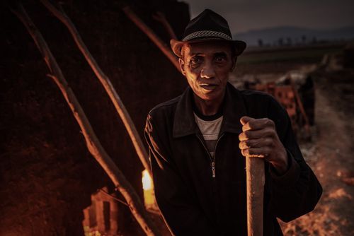Madagascar Travel Portraiture Portrait Photography Brick workers firing a kiln near Antsirabe Vakinankaratra Region Madagascar