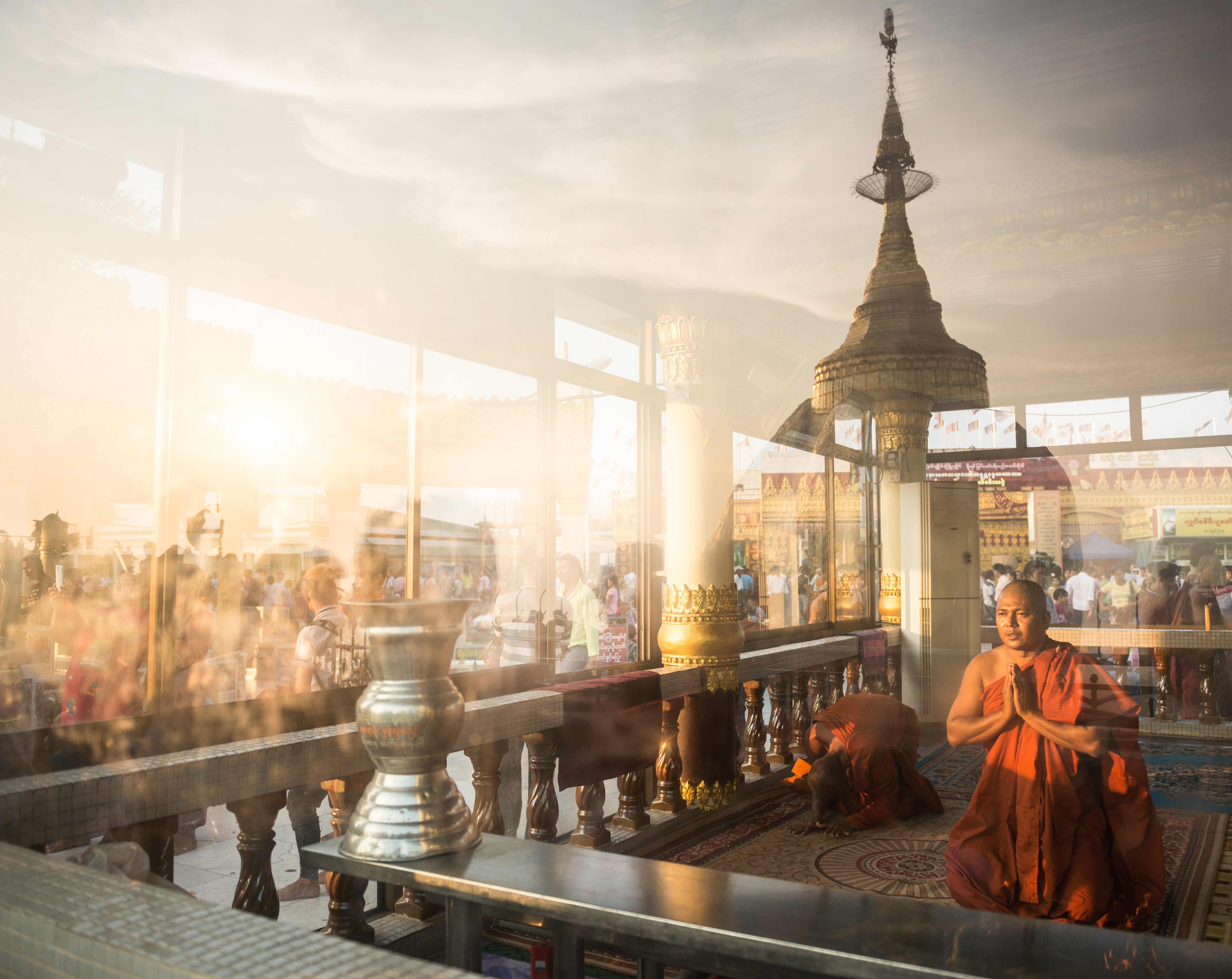 Myanmar Burma Travel Photography Buddhist Monks praying at Golden Rock Temple Kyaiktiyo Pagoda at sunset Mon State Myanmar Burma