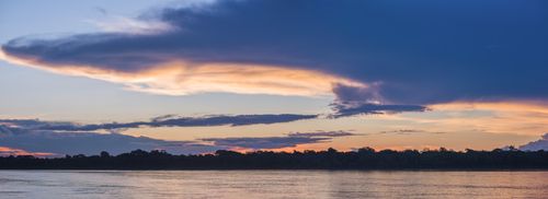 Peru Landscape Travel Photography Sunset over river in Amazon Jungle of Peru Tambopata National Reserve Peru South America