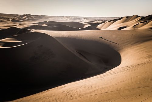 Peru Travel Photography Dune buggying in sand dunes at sunset in the desert at Huacachina Ica Region Peru South America