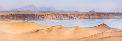 Peru Travel Photography Hikers hiking in desert in Paracas National Reserve Reserva Nacional de Paracas Ica Peru South America