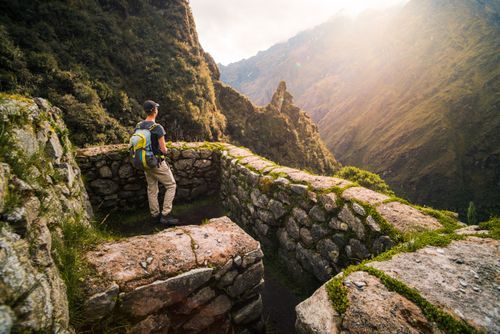 Peru Travel Photography Tourist at Inca ruins of a Tambo called Runkuraqay on Inca Trail Trek day 3 Cusco Region Peru South America