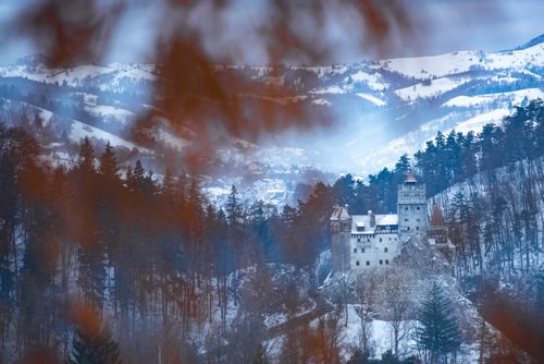 Romania Landscape Travel Photography Bran Castle covered in snow in winter Transylvania Romania