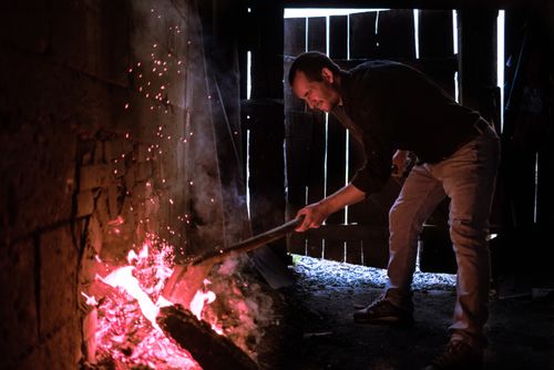 Romania Travel Portrait Photography Documentary Portraiture Firing up the Kiln at a Marginea Black Pottery and Ceramics workshop Bukovina Romania