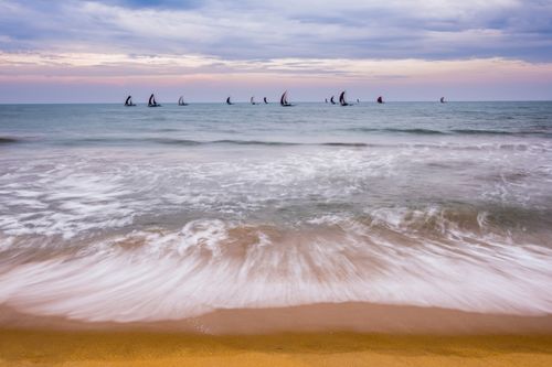 Sri Lanka Travel Photography Negombo traditional Sri Lankan oruva fishing boats returning at sunrise to Negombo fishing market seen from Negombo Beach Sri Lanka Asia