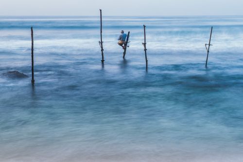 Sri Lanka Travel Photography Stilt fisherman fishing at Midigama near Weligama South Coast Sri Lanka Asia