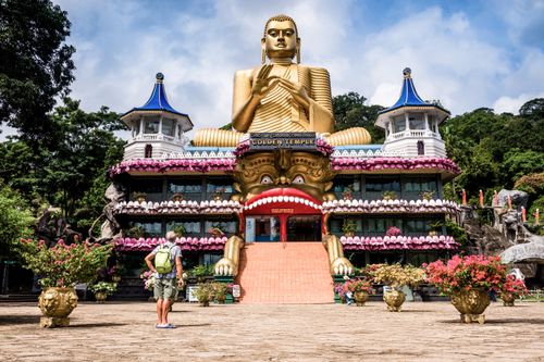 Sri Lanka Travel Photography Tourist visiting the Golden Temple of Dambulla in Dambulla Central Province Sri Lanka Asia