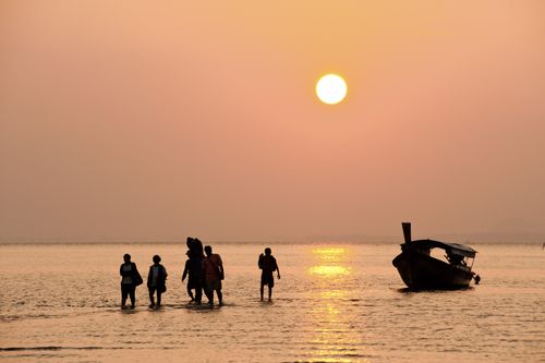 Thailand Travel Photography Silhouetted Tourists Arriving During Sunrise at East Railay Beach a Tropical Paradise in South Thailand Southeast Asia