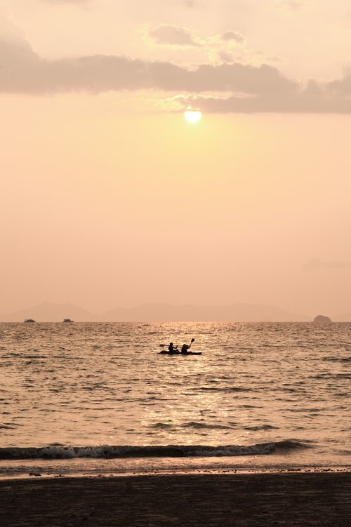 Thailand Travel Photography Tourist Couple Sea Kayaking at Sunrise at East Railay Beach Rai Leh South Thailand Southeast Asia