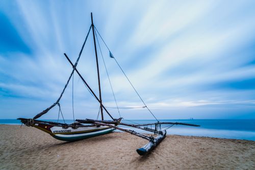 Landscape Photography by Professional Freelance UK Landscape Photographer Outrigger fishing boat on Negombo Beach at sunrise Sri Lanka Asia