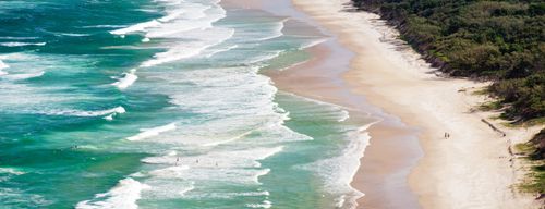 Landscape Photography by Professional Freelance UK Landscape Photographer Panoramic Photo of Surfers Heading Out to Surf on a Deserted Tallow Beach at Byron Bay Gold Coast Australia