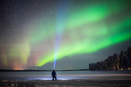 Landscape Photography by Professional Freelance UK Landscape Photographer Person under Northern Lights aurora borealis display of amazing bright colourful green and purple Lapland inside Arctic Circle in Finland