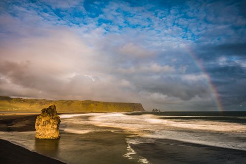 Landscape Photography by Professional Freelance UK Landscape Photographer Reynisdrangar Basalt Sea Stacks and rainbow seen from Dyrholaey Peninsula at sunset near Vik South Iceland Sudurland