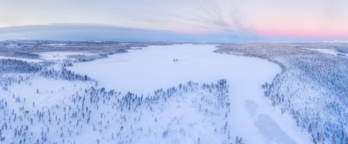 Landscape Photography by Professional Freelance UK Landscape Photographer Snow covered lake and forest winter landscape showing amazing Lapland scenery in Scandinavia in Finland drone